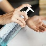 Woman using hand sanitizer