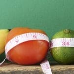 Weight loss depiction of fruits and tape measure