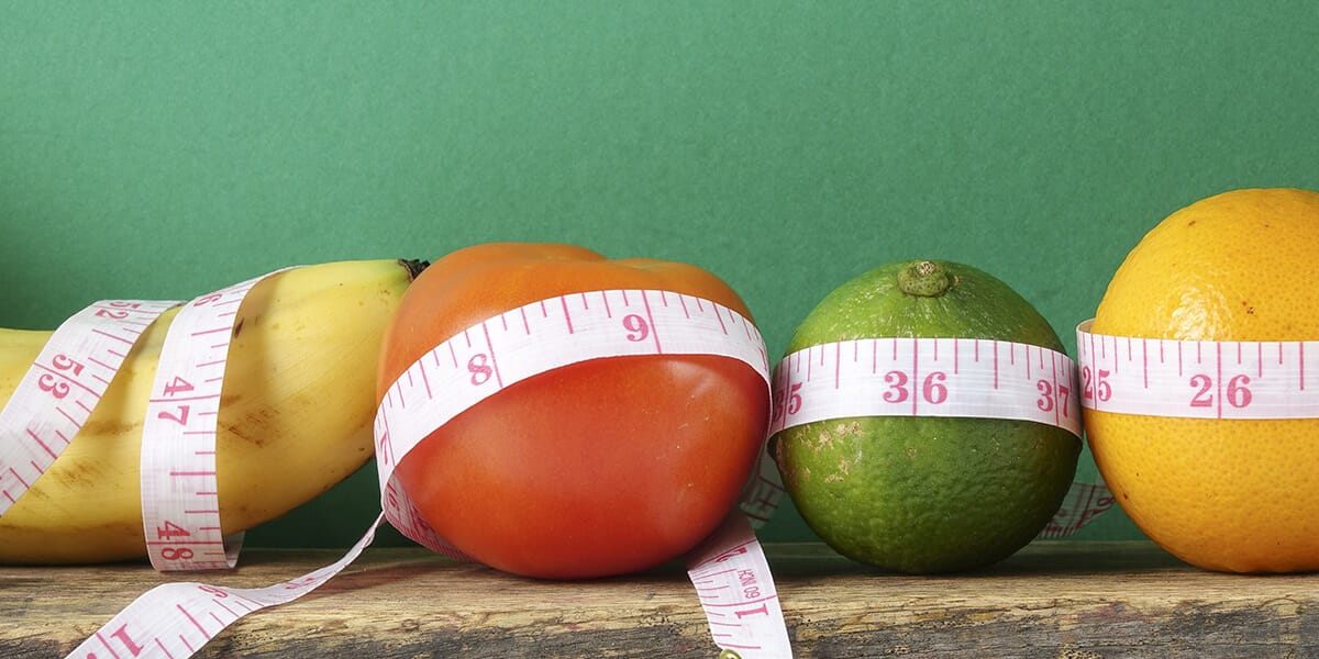 Weight loss depiction of fruits and tape measure