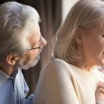Older woman with shortness of breath with concerned husband