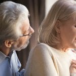 Older woman with shortness of breath with concerned husband