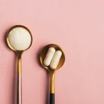 Collagen powder and pills on gold spoons